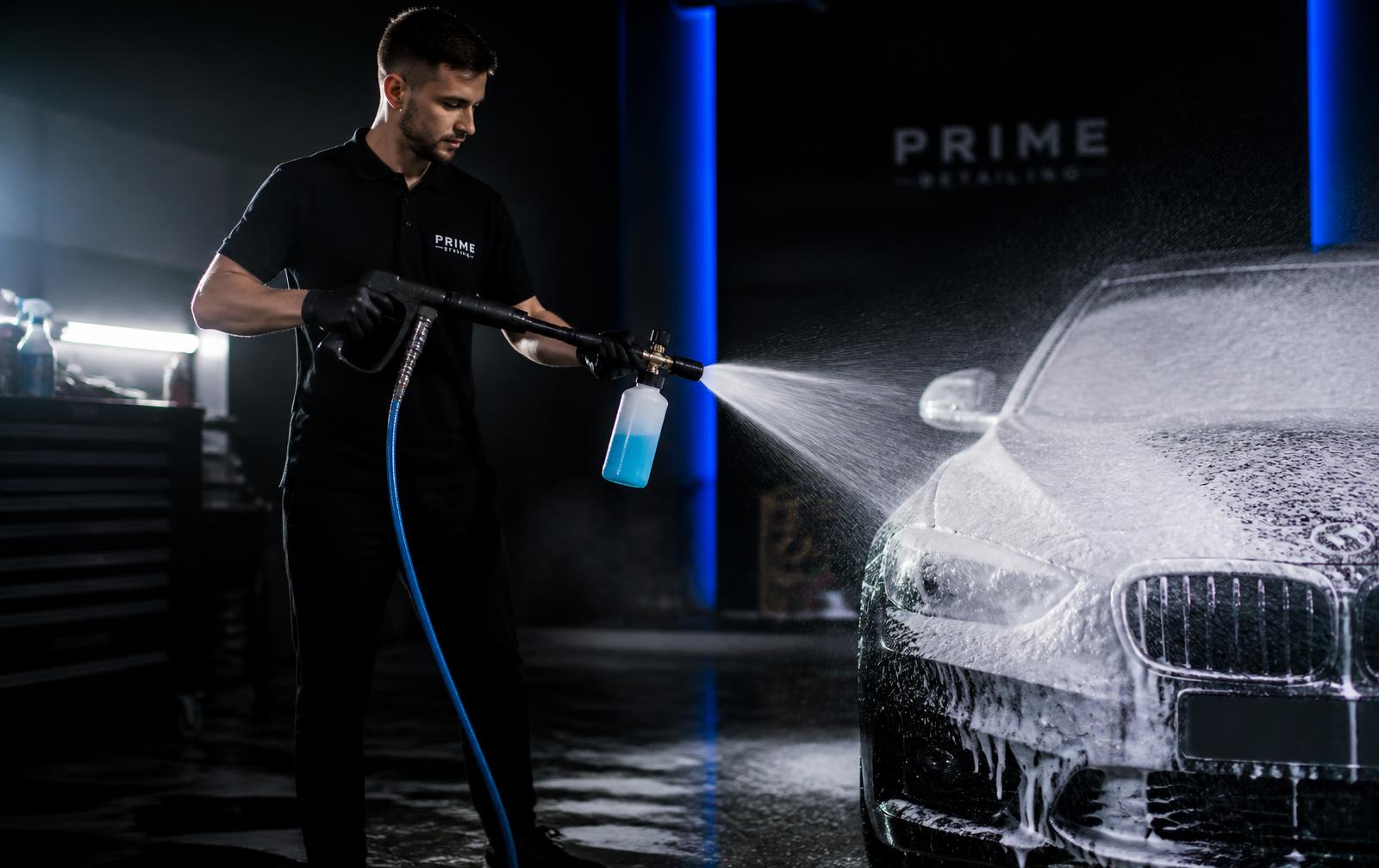 Detailer polishing a vehicle by hand at Leo's Detailing